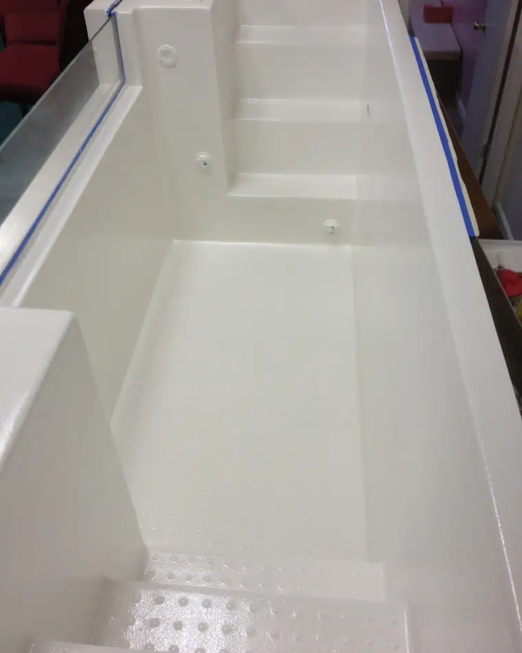 The same baptismal pool after refinishing, the shell, steps and floor re-coated to an even gloss white.